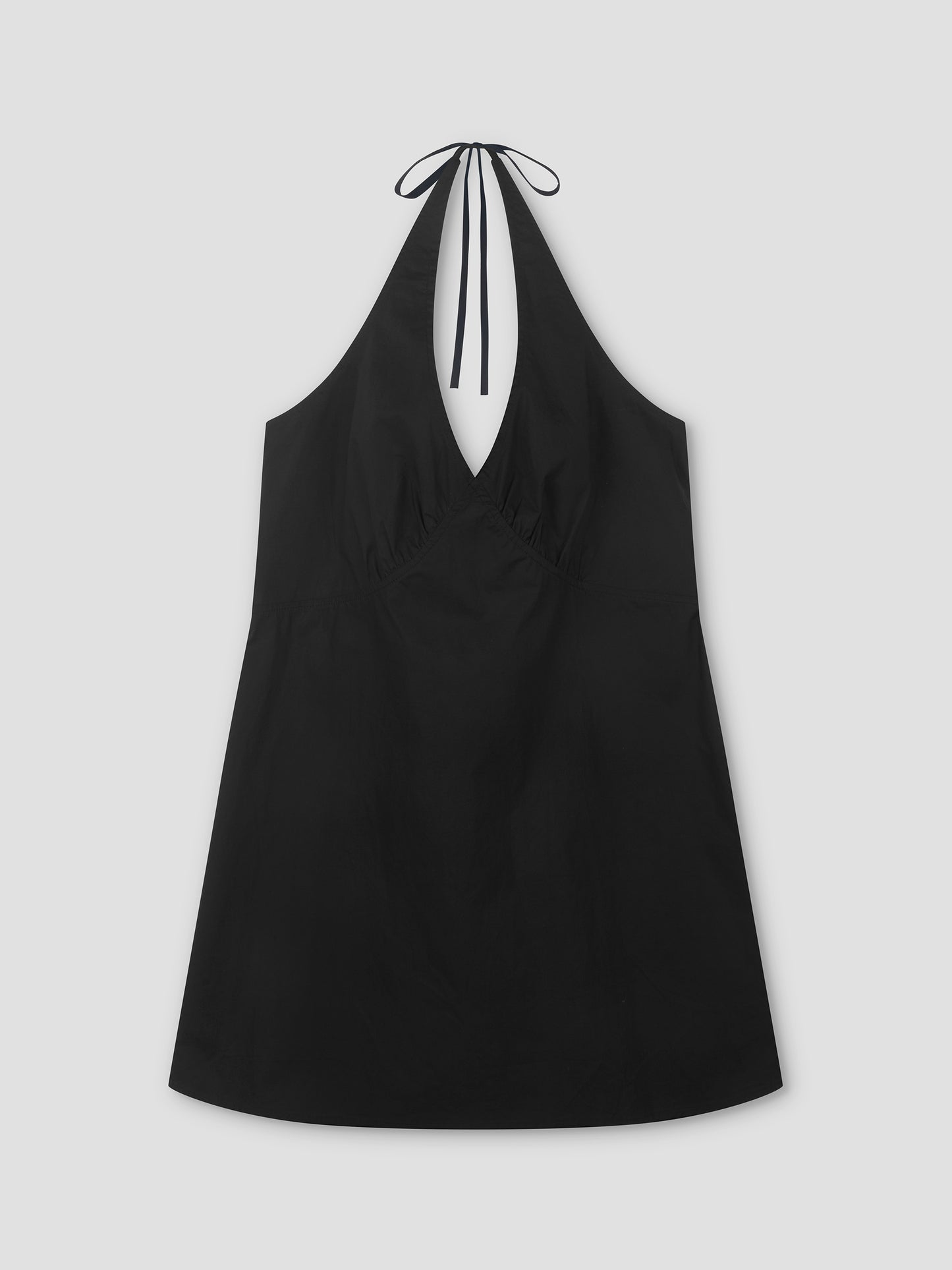 The Cinched Halter Dress - Black is a lightweight dress with a deep V-neckline and slight hem flare, shown laid flat on a light gray background.