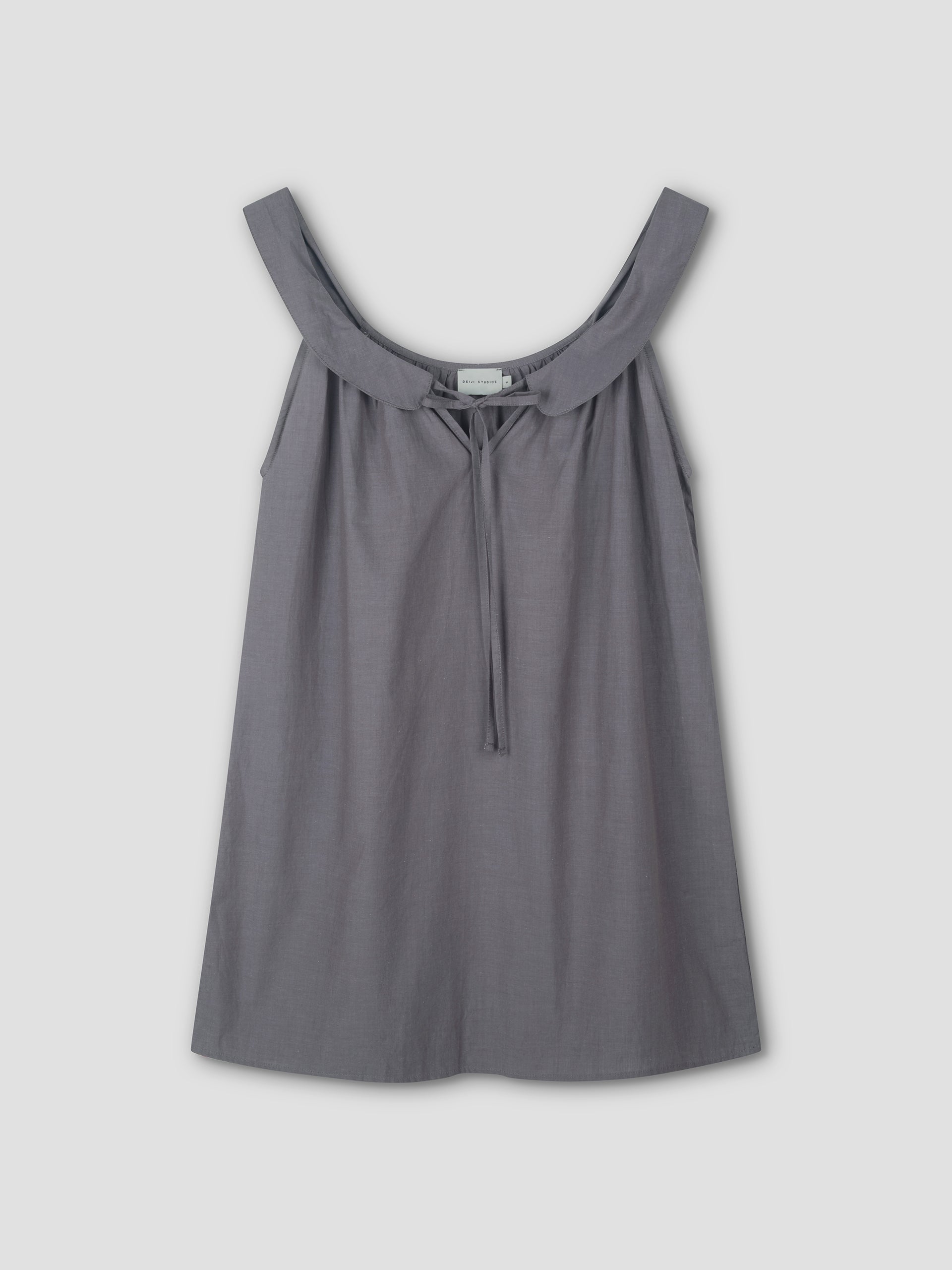 The Rounded Neck Dress - Currant features a sleeveless design with a wide, scooped neckline and front tie detail, shown against a plain light background.