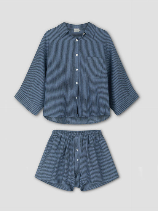 The 03 Set - Azure Stripe from Deiji Studios: blue pinstriped linen pajamas with a long-sleeve, button-up shirt and elastic-waist boxer shorts, both displayed flat on a white background.