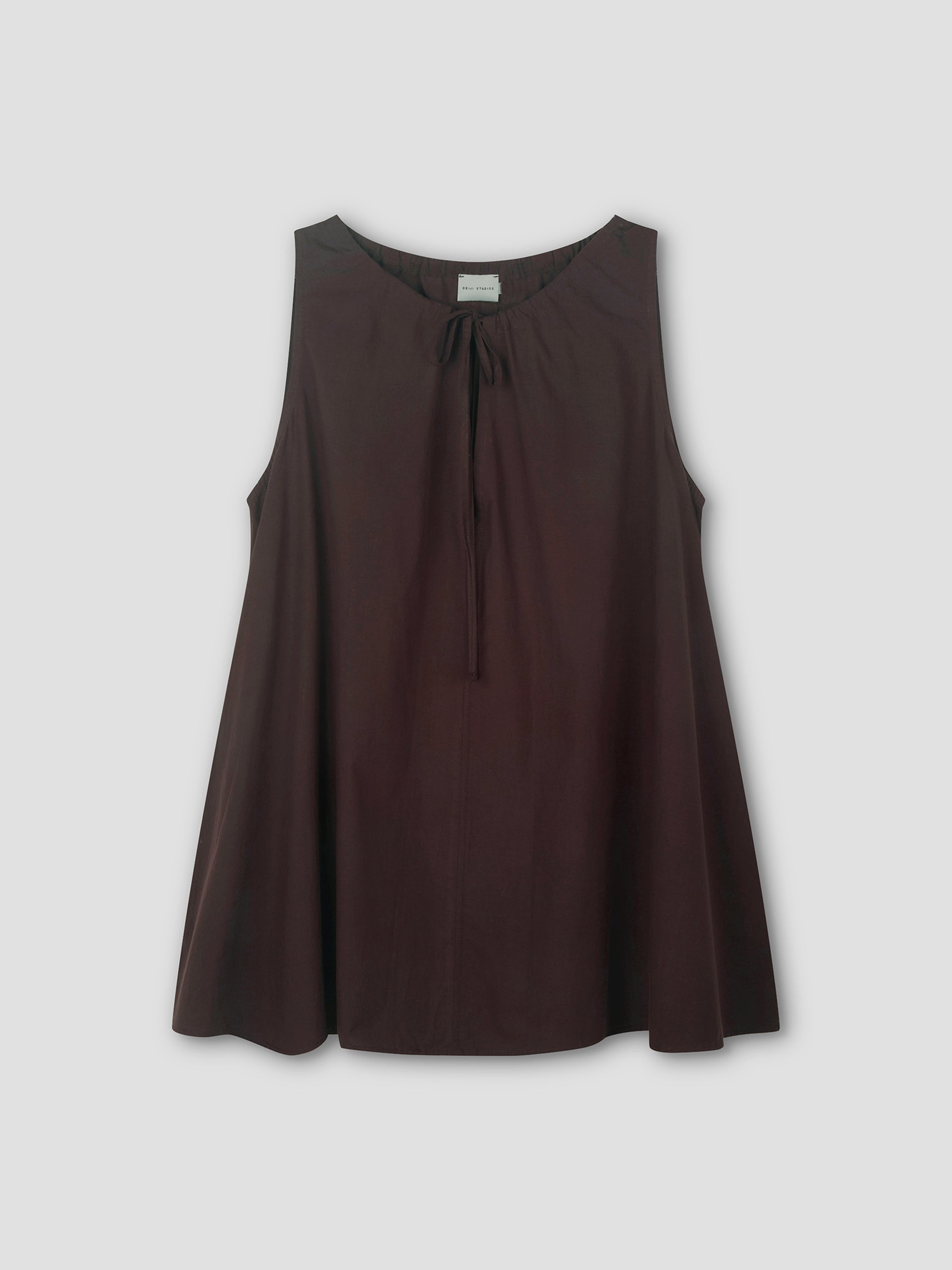 The Drawcord Dress in sepia is sleeveless and loose-fitting, with a round neckline and tie detail, featuring an A-line silhouette. Shown against a light grey background.