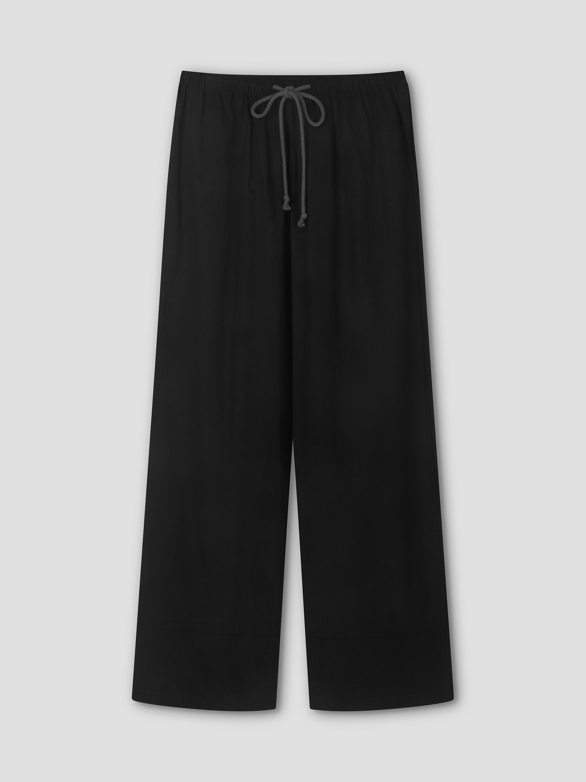 The Layered Pant - Black by Deiji Studios is a black wide-leg relaxed pant featuring an elastic waistband and visible drawstring, shown flat against a light gray background—a minimalist wardrobe staple.