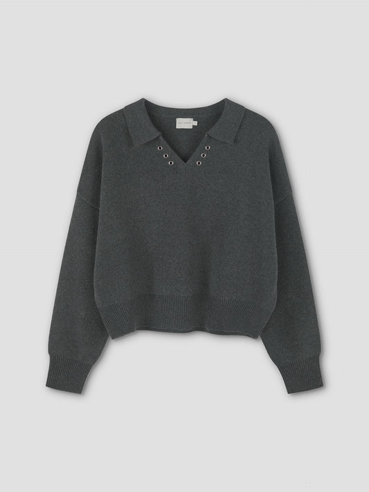 The Eyelet Knit - Dark Pebble is a dark gray, relaxed long-sleeve sweater by Deiji Studios with a collar, V-neckline, eyelet knit details on the front, and ribbed hem and cuffs for added structure to its slightly cropped fit.