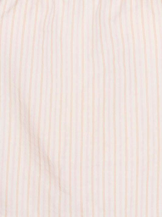 Close-up of the Simple Top - Dusty Stripe by Deiji Studios, crafted from organic cotton in white with evenly spaced, thin dusty pink vertical stripes. The fabric looks soft, slightly wrinkled, and breathable.