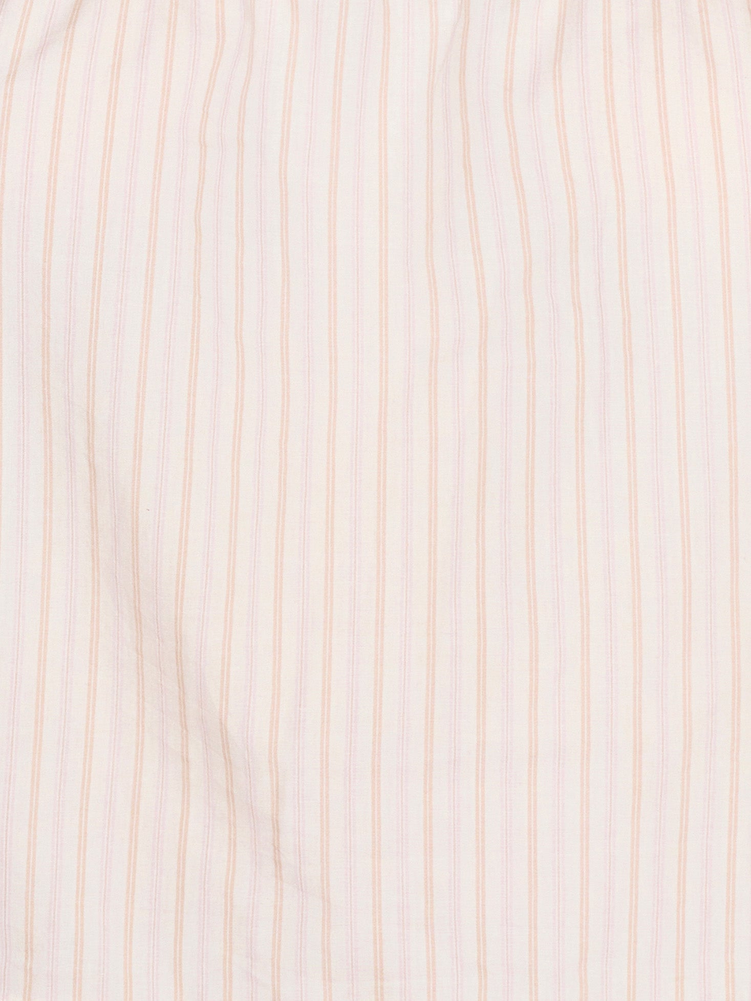 A close-up of the Room Shirt - Dusty Stripe by Deiji Studios shows its organic cotton fabric with evenly spaced thin vertical pink stripes on a white background.