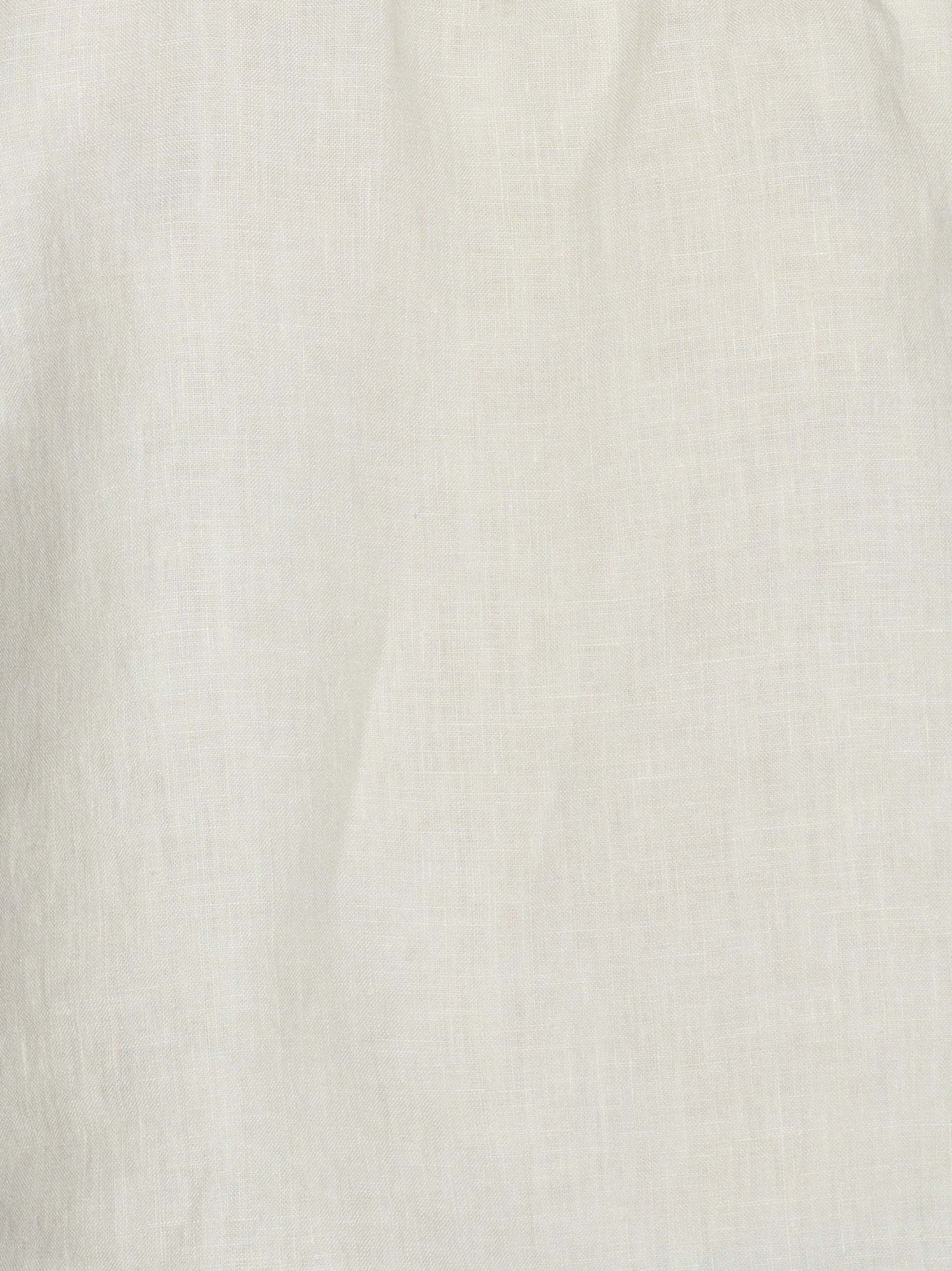 Close-up of the Strapless Linen Dress in Pastel Pistachio, showcasing its off-white organic linen fabric with subtle woven texture and soft, natural folds.