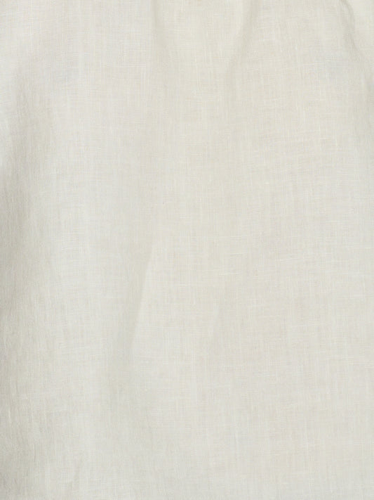 Close-up of the Strapless Linen Dress in Pastel Pistachio, showcasing its off-white organic linen fabric with subtle woven texture and soft, natural folds.