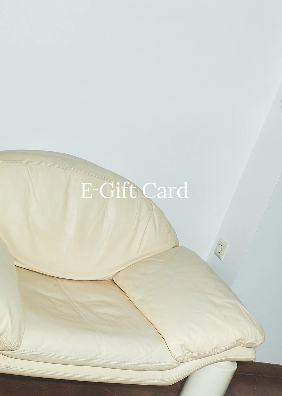 Leather sofa against plain wall with text 'Gift Card'