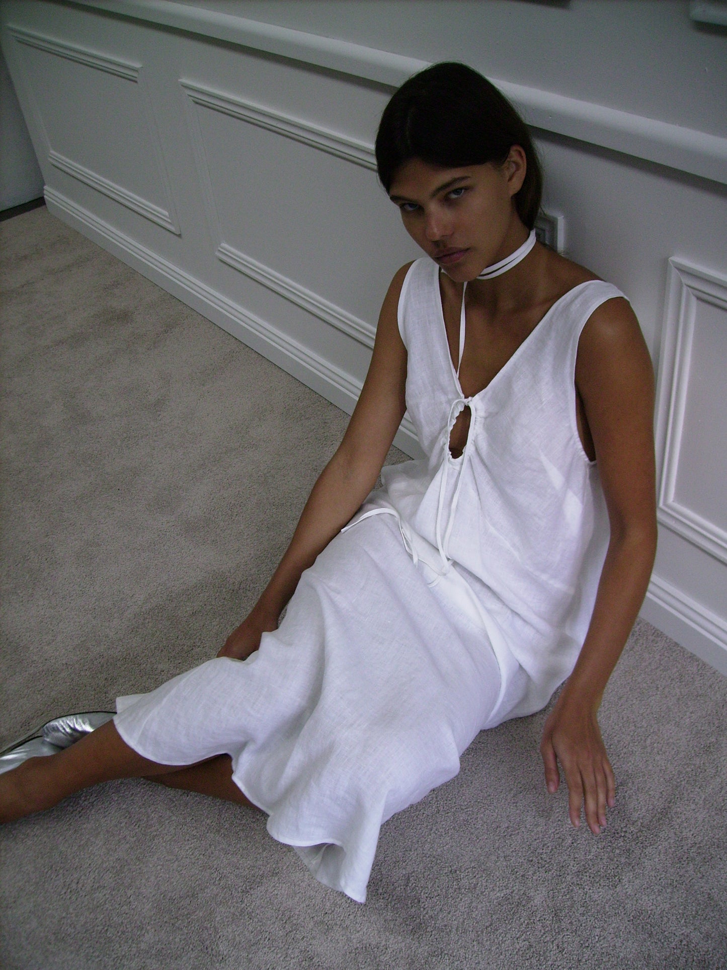 Female model wearing Keyhole Dress - White by Deiji Studios against plain background