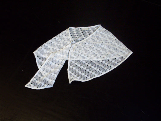 The Thread Button Belt in off white is displayed flat on a black surface, with one end folded over the other.