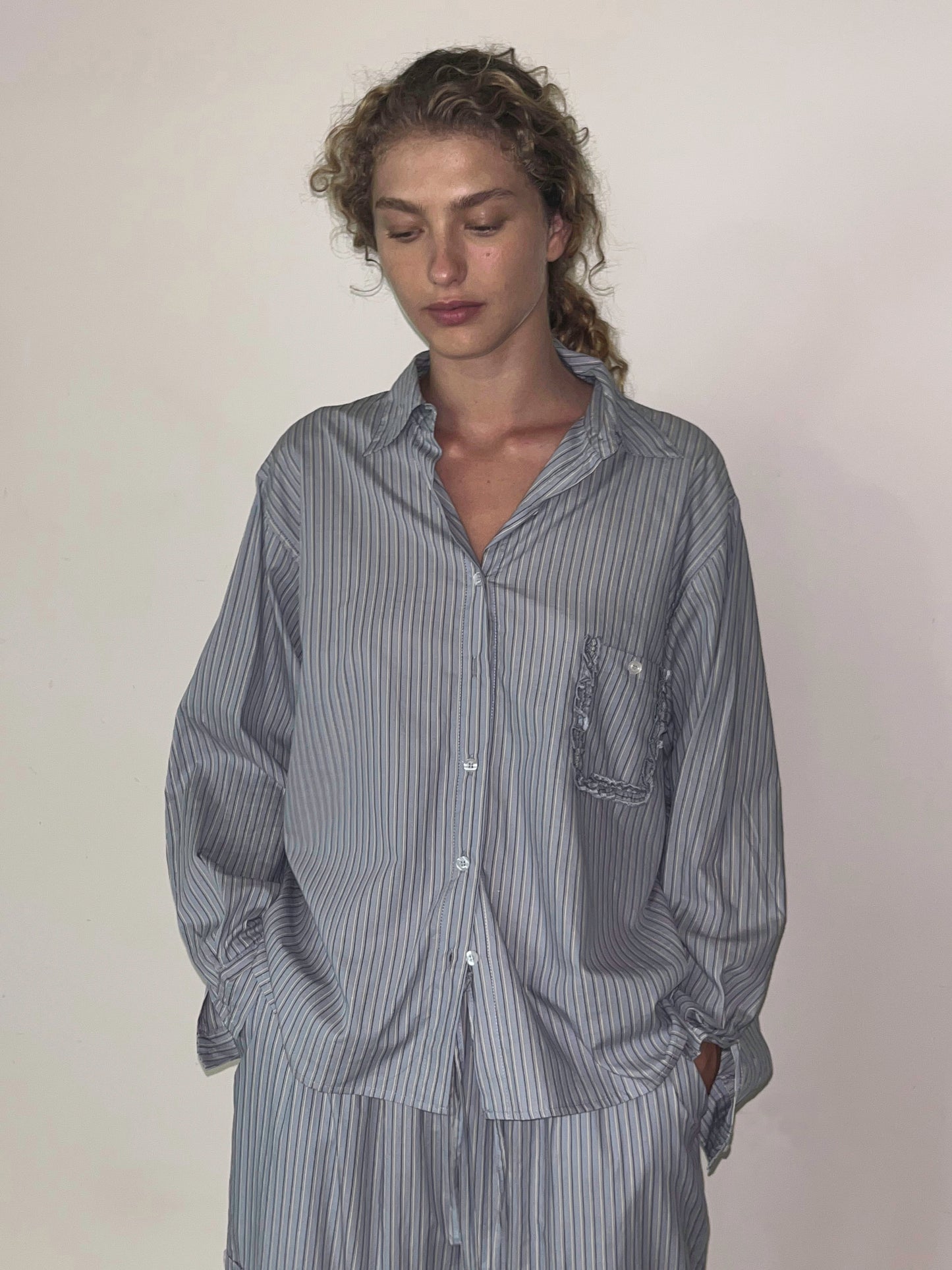 Female model wearing Cotton Pyjama Set - Glacier Stripe by Deiji Studios against plain background