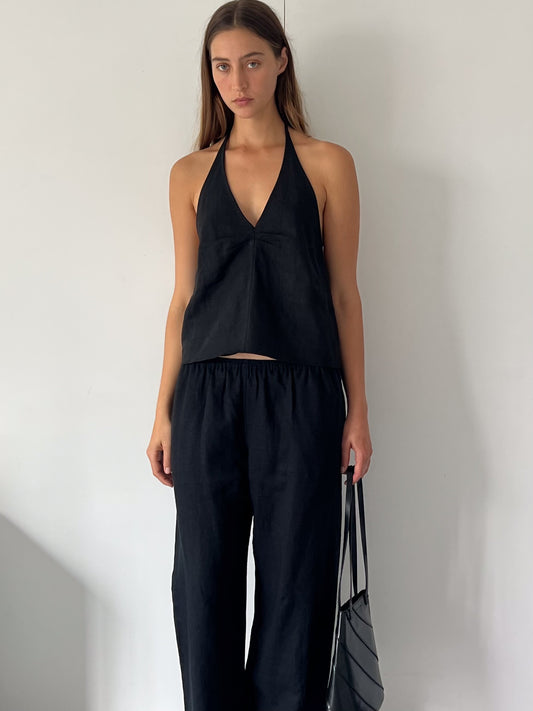 female model wears the linen pinched halter top by Deiji Studios in black

relaxed halter top features flattering v neckline, centre bust pleats and adjustable backline with drawcord tie closure

made from 100% OEKO-TEX 100 certified and EU certified stone washed french linen

paired with a black linen trouser