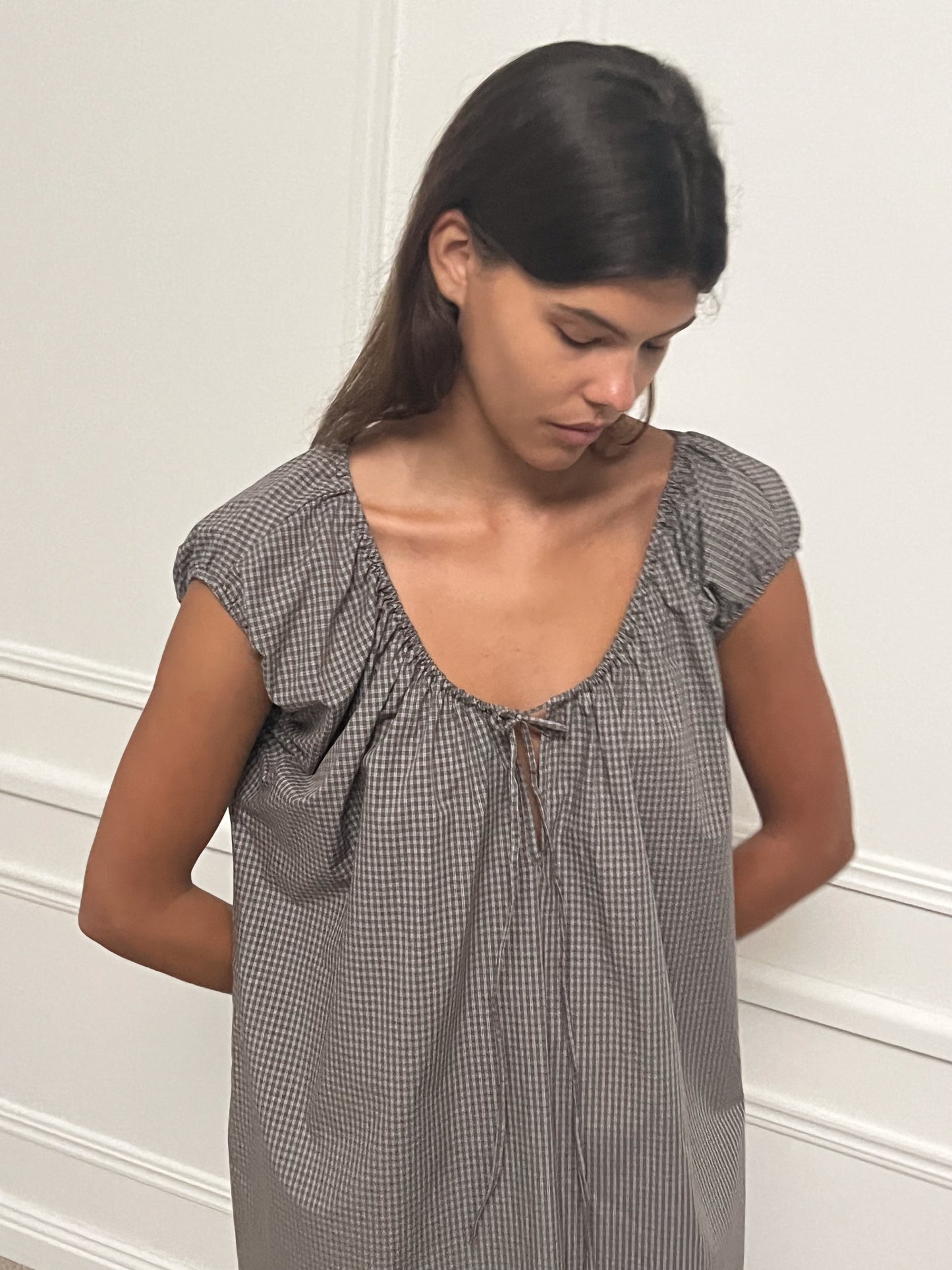 Female model wearing Capped Sleeve Dress - Khaki Check by Deiji Studios against plain background