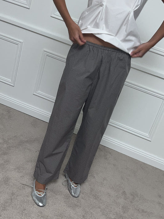 Female model wearing Ease Trouser - Khaki Check by Deiji Studios against plain background