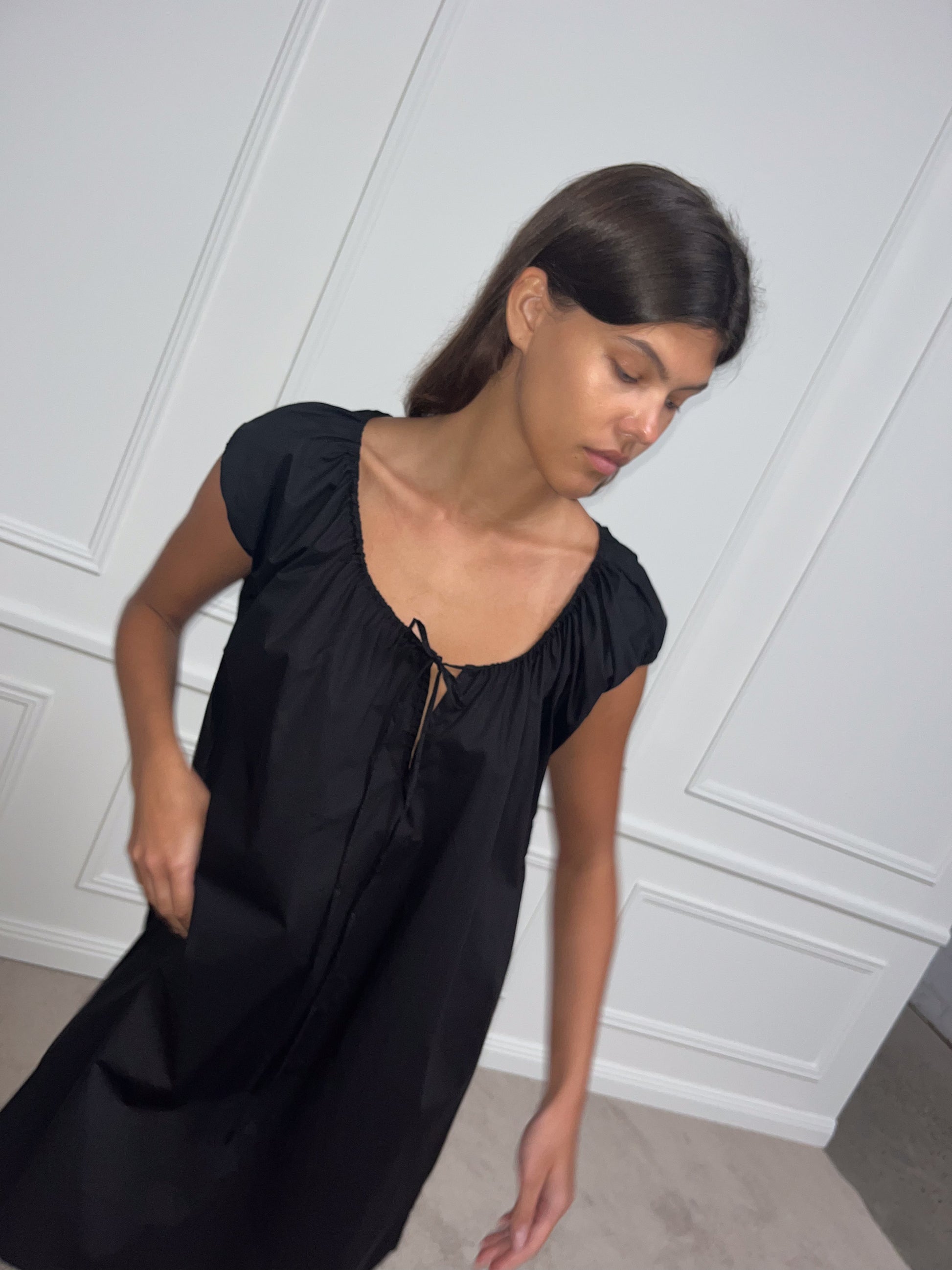 Female model wearing Capped Sleeve Dress - Black by Deiji Studios against plain background