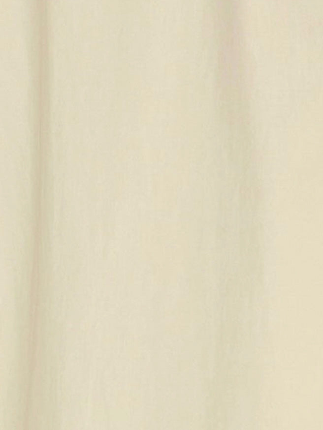 A close-up view of a soft, plain butter yellow fabric with subtle vertical folds, reminiscent of the Double Seam Dress by Deiji Studios made from organic cotton.