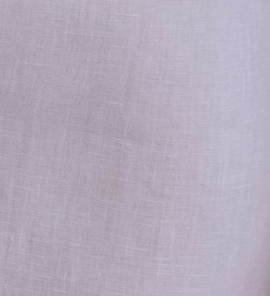 Close-up of the Linen Ease Trouser in lilac, crafted from organic French linen with a subtle weave texture and a soft, slightly translucent finish.