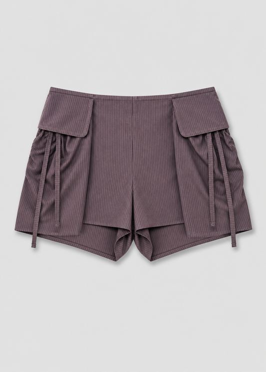 The Deiji Studios Micro Pocket Short in Mulberry Stripe features a high waist, wide leg openings, large flap pockets, and decorative side fabric ties, shown here against a plain light background.