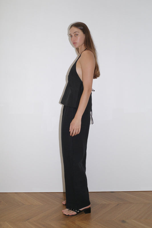 female model wears the linen pinched halter top by Deiji Studios in black

relaxed halter top features flattering v neckline, centre bust pleats and adjustable backline with drawcord tie closure

made from 100% OEKO-TEX 100 certified and EU certified stone washed french linen

paired with a black linen trouser