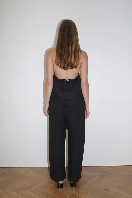 female model wears the linen pinched halter top by Deiji Studios in black

relaxed halter top features flattering v neckline, centre bust pleats and adjustable backline with drawcord tie closure

made from 100% OEKO-TEX 100 certified and EU certified stone washed french linen

paired with a black linen trouser