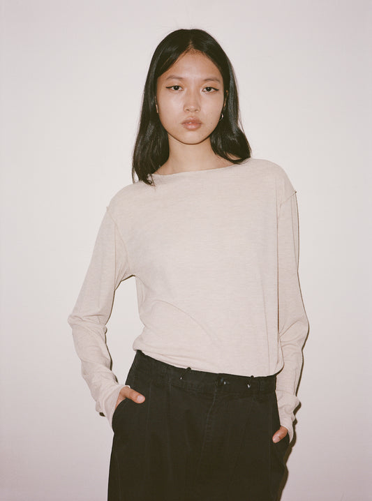 Female model wearing The Knit Long Sleeve - Oat by Deiji Studios against plain background