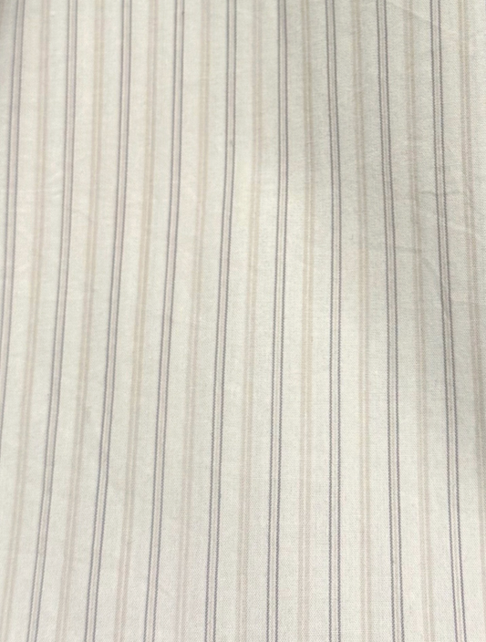 Close-up of the Napkin Belt - Pacific Stripe, crafted from smooth organic cotton featuring light-colored fabric with thin, evenly spaced darker vertical pinstripes and subtle wrinkles—true to Deiji Studios’ style.