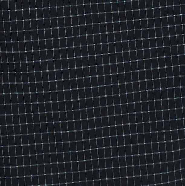 A close-up of the "Buttoned Mini Dress - Mono Grid" fabric reveals a dark base adorned with a grid pattern of thin, light-colored intersecting lines, forming small square shapes—ideal for creating a sophisticated buttoned mini dress or an elegant shift dress.