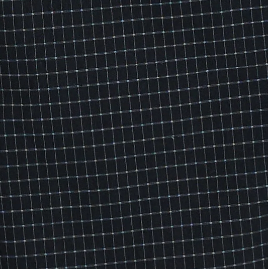 A close-up of the "Buttoned Mini Dress - Mono Grid" fabric reveals a dark base adorned with a grid pattern of thin, light-colored intersecting lines, forming small square shapes—ideal for creating a sophisticated buttoned mini dress or an elegant shift dress.