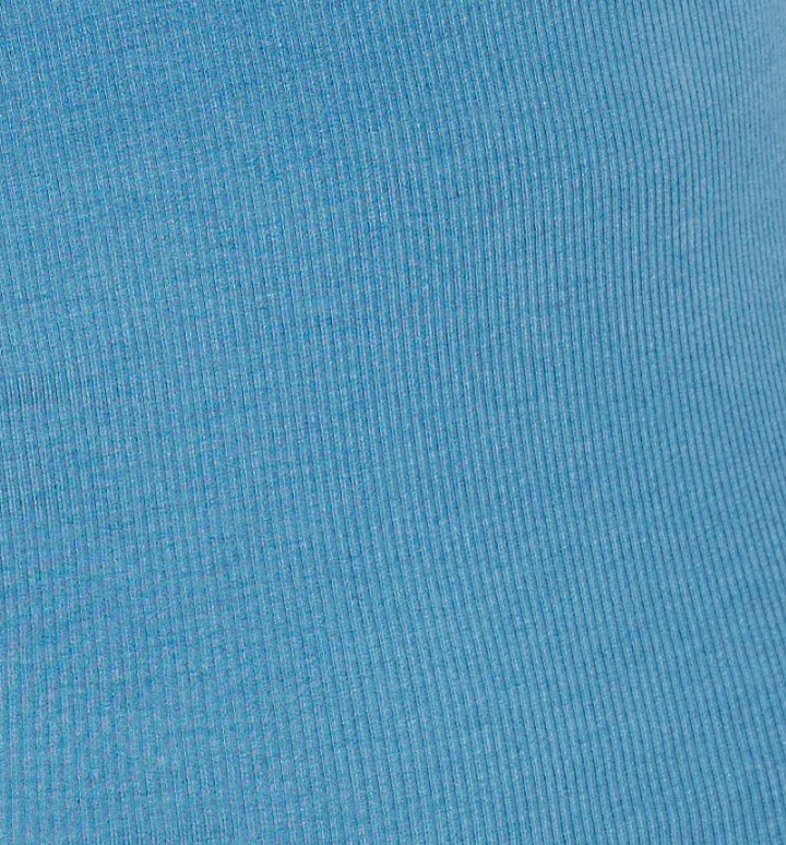 Close-up of the aqua ribbed fabric with vertical textured lines, showcasing a subtle pattern that highlights the stretch and weave—ideal for the Multi Button Top, designed as a long sleeve jersey with an asymmetric scoop neckline.