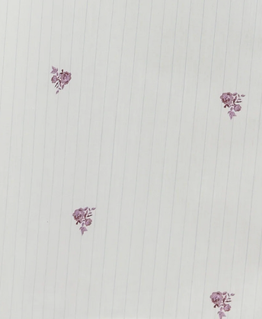 Certainly! Here’s a revised version of the sentence using your product data: The Bow Dress - Floral Stripe features thin vertical blue floral stripe lines and small clusters of purple flowers spaced apart across a white background.