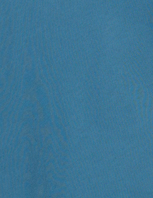 Close-up of a blue fabric with a soft, slightly textured surface and subtle wavy lines visible throughout, reminiscent of the refined materials used in the Cuff Tie Top - Teal from Deiji Studios.