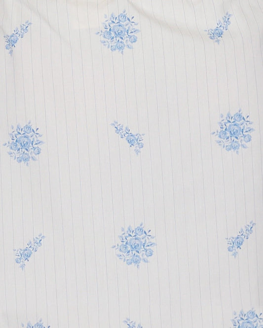 White organic cotton fabric with thin vertical blue pinstripes and small blue floral clusters in a repeating pattern, ideal for a Deiji Studios-inspired look like the Cotton Pyjama Set - Sea Flower.
