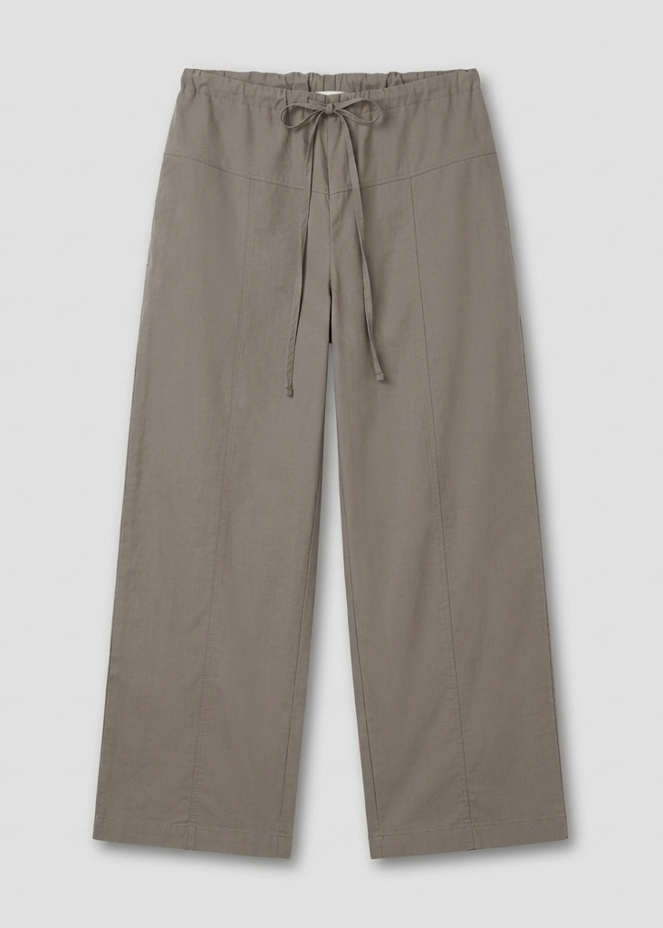 The Seam Pant - Light Khaki by Deiji Studios is a wide-leg, relaxed-fit pant with an elastic waistband, drawstring tie, and visible front seams, displayed flat against a plain light background.
