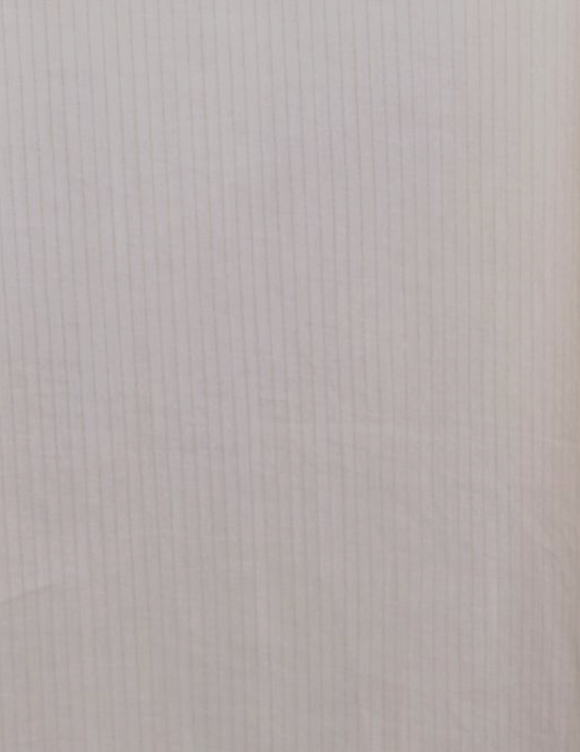 Light pink sheet of lined paper with faint grid lines forming small squares—its pastel tone is as soft as a Button Frill Mini Dress - Stone Stripe, appearing blank and pristine.