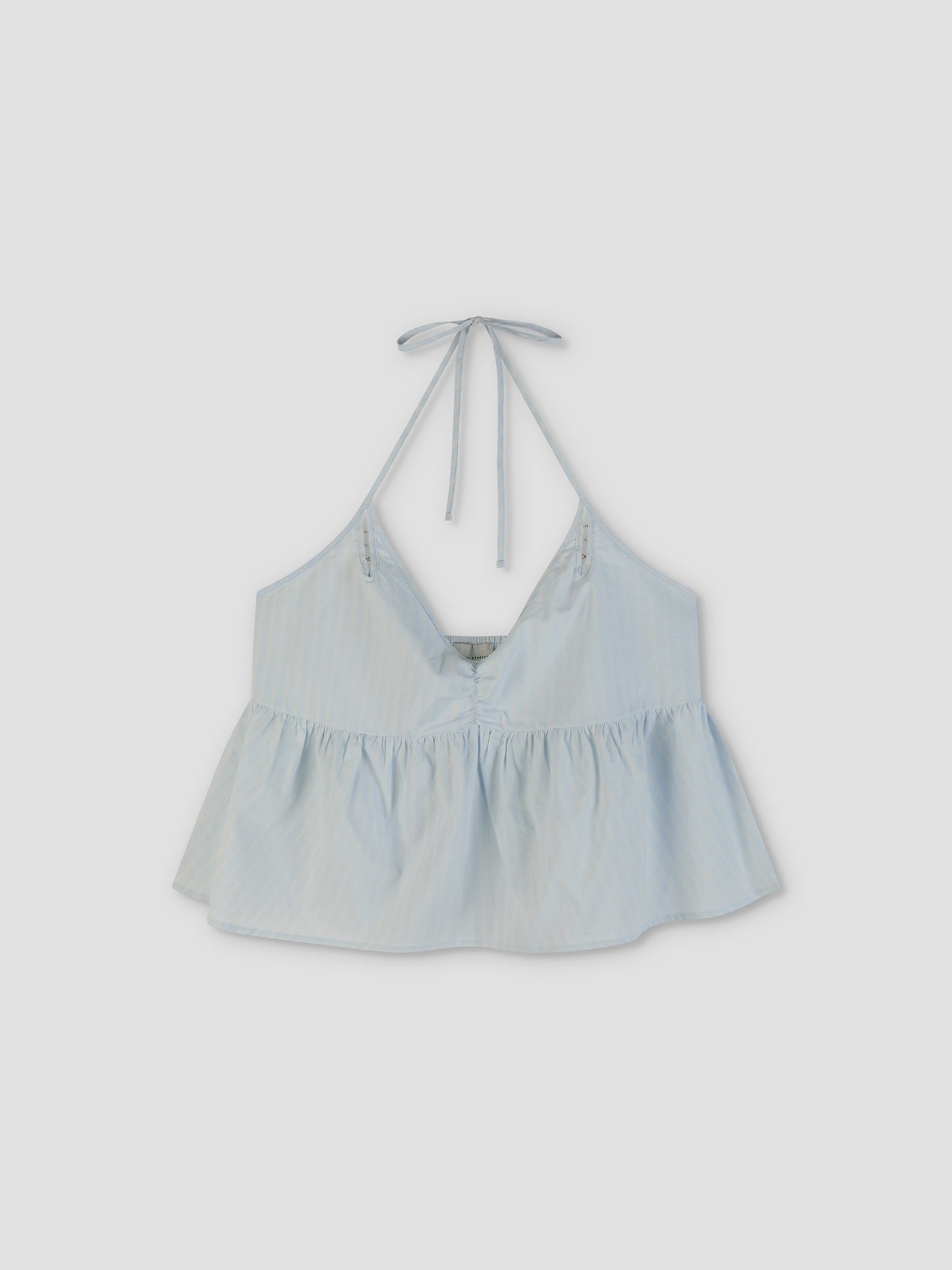 The Keyhole Halter Top in Powder Blue Stripe features a sleeveless, V-neck design with a keyhole tie at the neck, loose ruffled hem, and flowy silhouette inspired by Deiji Studios’ effortless style.