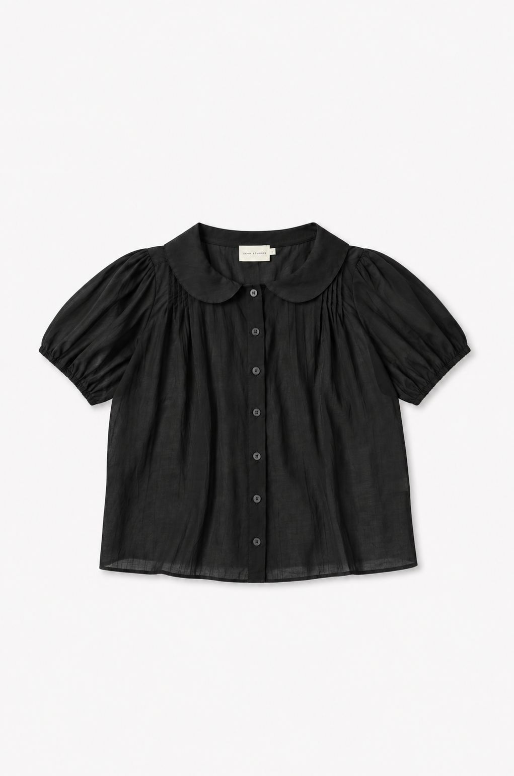 The Petal Top - Black by Deiji Studios laid flat against a plain white background, a lightweight cotton voile top with a rounded peter pan collar, button-through front and gently puffed short sleeves.