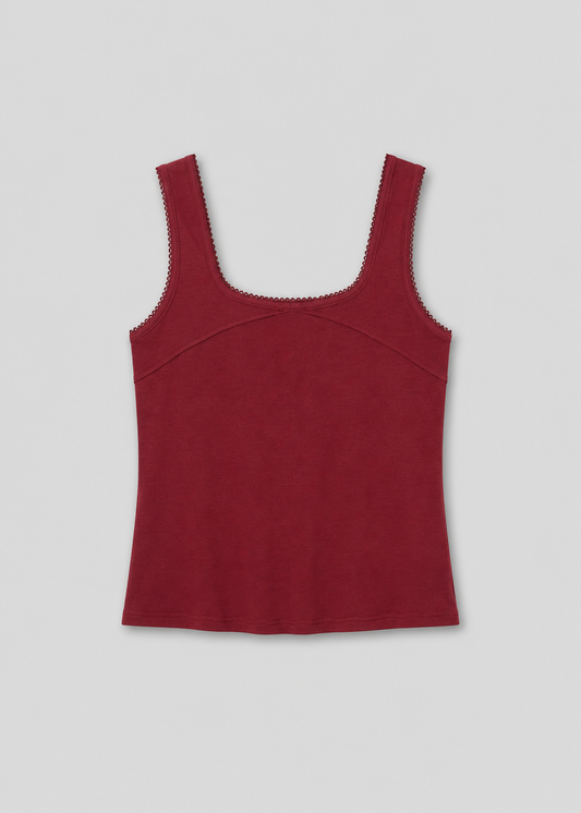 The Piping Tank - Crimson is a sleeveless, square-neckline top in dark red with scalloped trim on the neckline and armholes, shown flat on a light background—a chic style inspired by Deiji Studios.