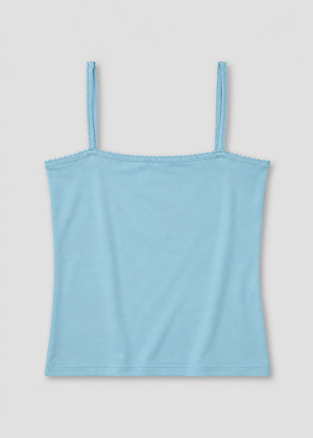 The Scallop Tank - Sky by Deiji Studios laid flat against a plain white background, a fitted ribbed tank in sky blue with fine shoulder straps and scallop trim along the straight neckline and straps.