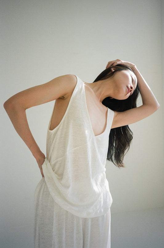 Female model wearing soft tank - ecru by Deiji Studios against plain background
