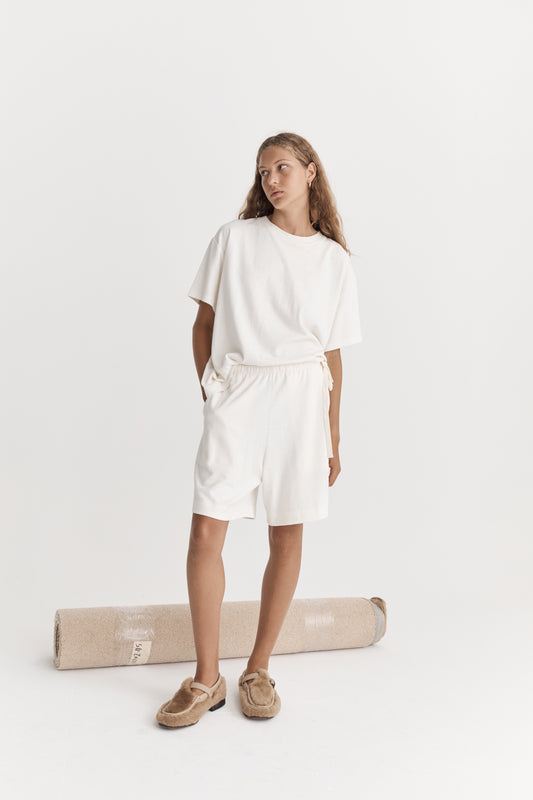 Female model wearing the jersey short - bone by Deiji Studios against plain background