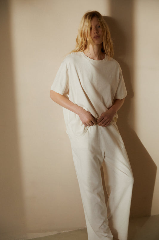Female model wearing the jersey pant - bone by Deiji Studios against plain background