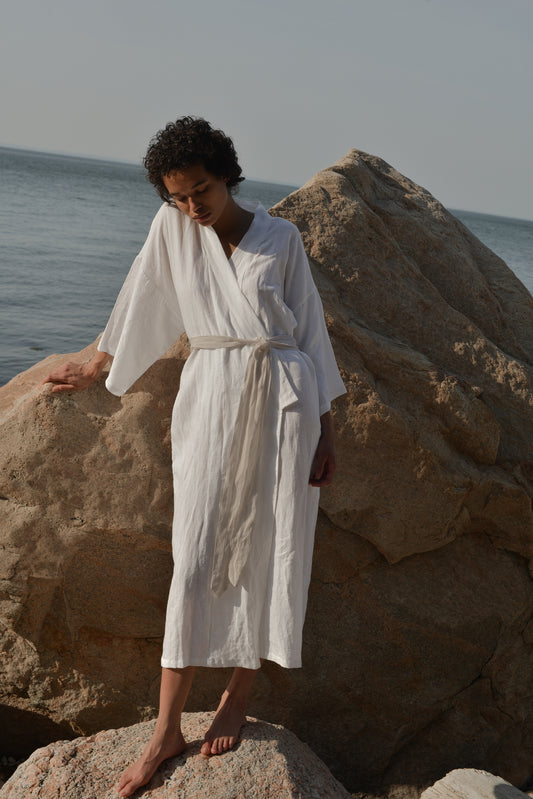 Female model wearing the 02 robe - white by Deiji Studios against plain background