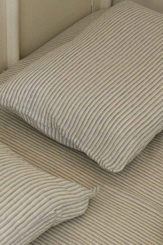 Light room with queen bed and pillows topped with Pillow slip set - River Stripe by Deiji Studios